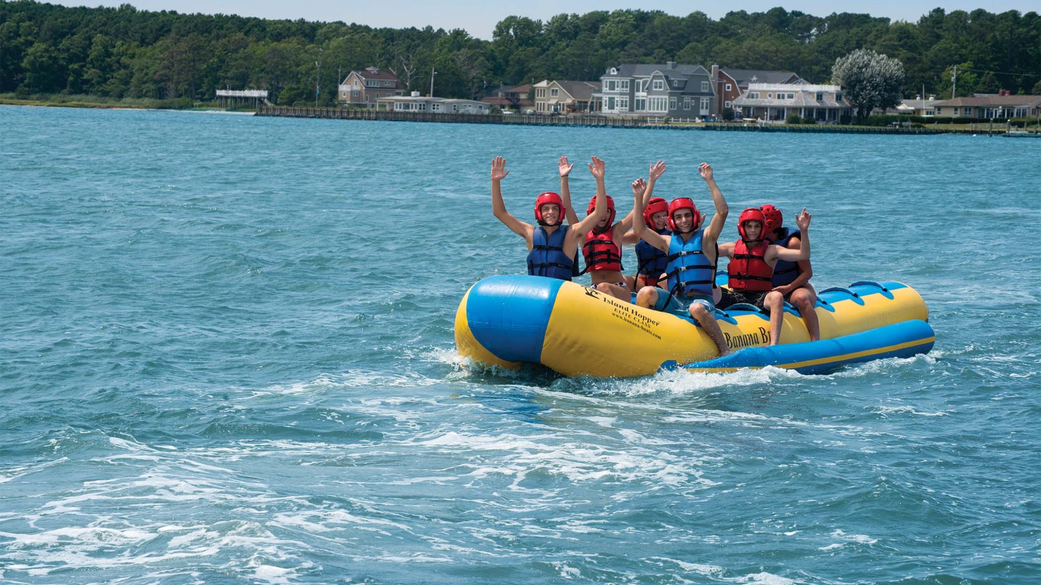 a group of people in a small boat in a body of water
