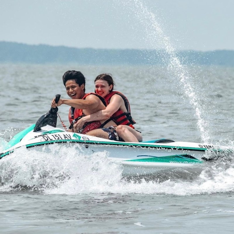 a young girl riding a wave on a surfboard in the water